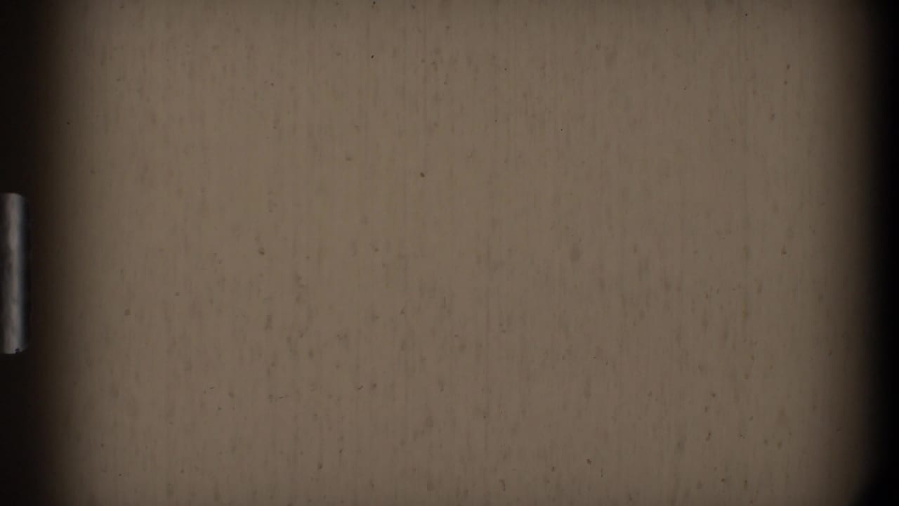 Mostly blank beige film frame with dark film gate edges.