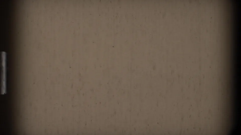 Blank or near-blank 8mm frame with beige exposure, dark gate edges, dust, and no visible people.