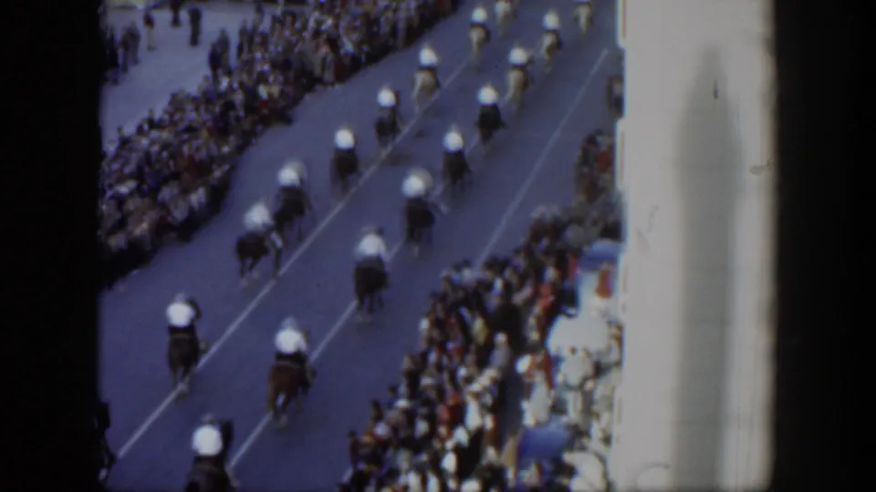 Elevated 1951 Texas parade view with mounted riders in formation and spectators packed along the curb.