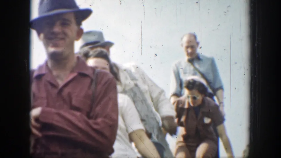 Adults in period casual clothing and hats appear in bright daylight during the 1937 California hiking outing.