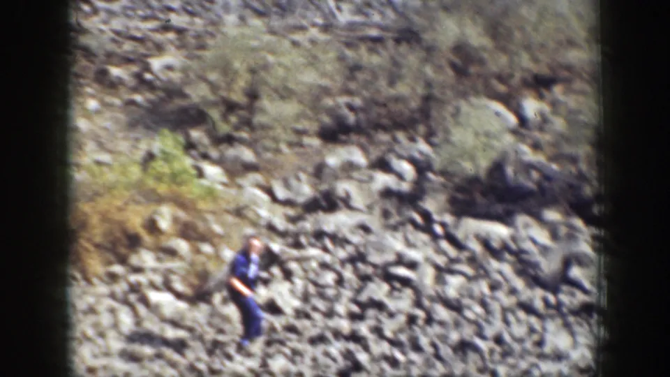 A distant figure in dark clothing appears on a rocky California slope in 1937 home-movie footage.