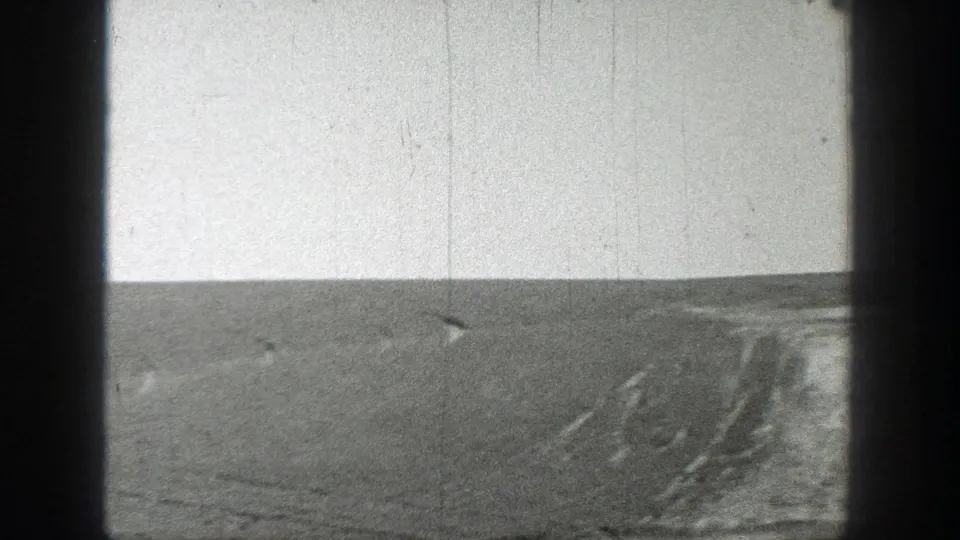 1937 California 8mm frame showing barren ground, faint track marks, and an empty horizon with no people or signage visible.