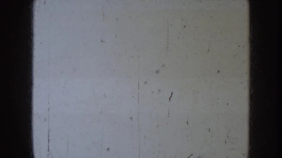 The final frame is largely blank or overexposed, showing pale film texture, scratches, and the 8mm frame edge rather than clear action.