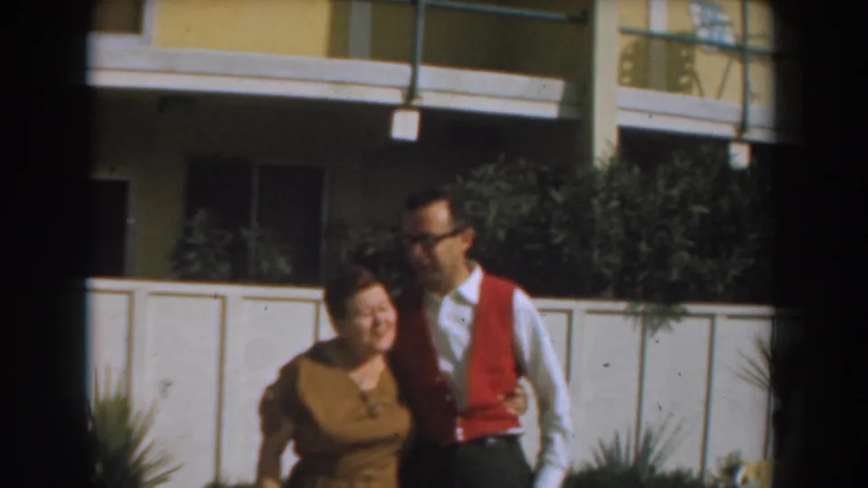 The man leans toward the woman as they stand together outside a Los Angeles apartment building in 1961.