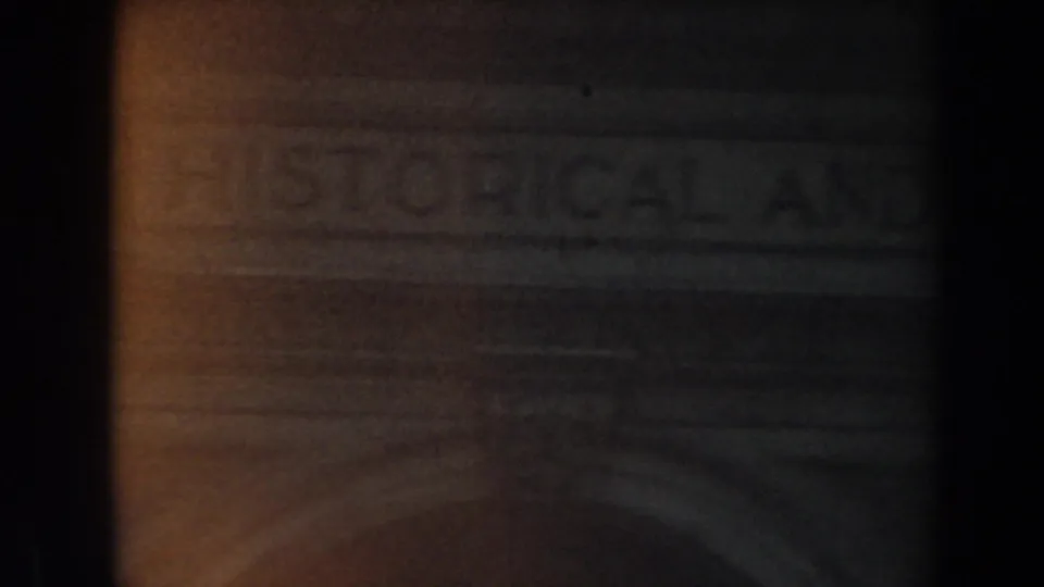 1961 Los Angeles 8mm frame showing a dark stone entrance area with indistinct lettering above the doorway.