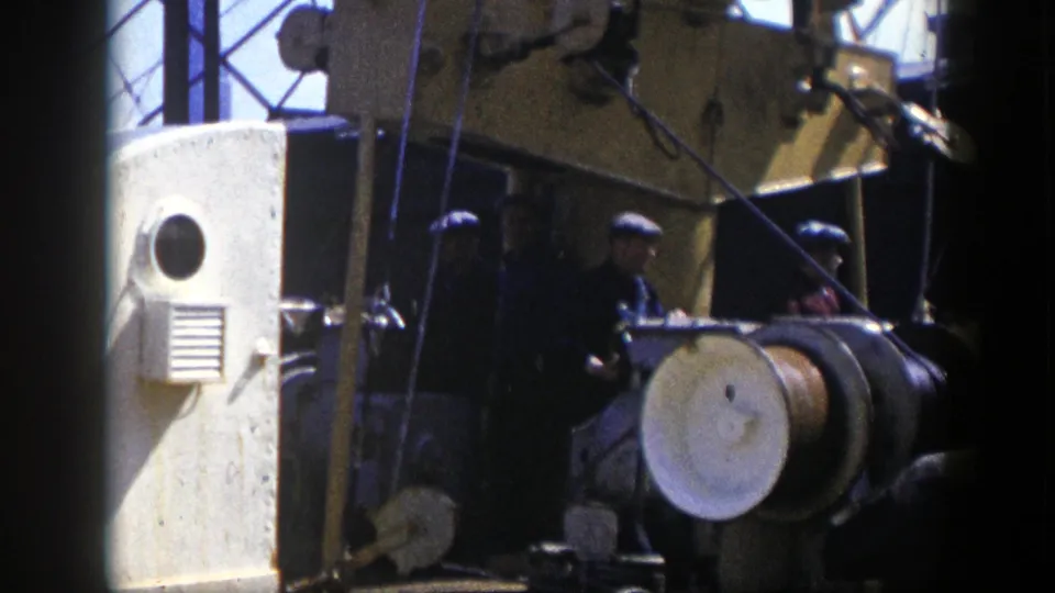 1948 New York industrial footage showing capped workers around large machinery and a prominent spool or drum.