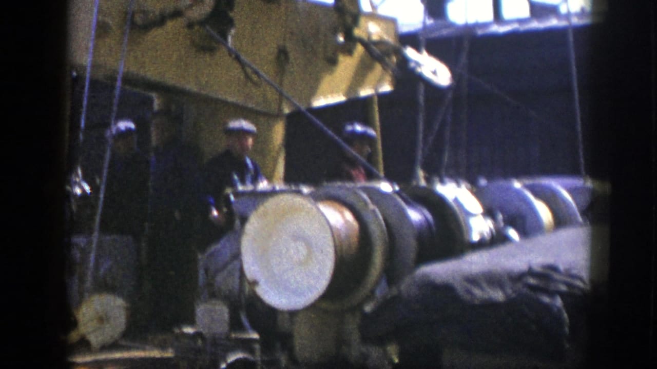 1948 New York harbor footage appears to show sailors on a large vessel near cylindrical deck equipment and rigging.