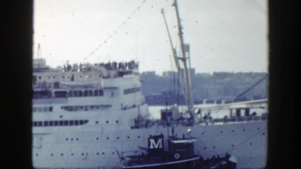 A soft 8mm view frames the Atlantic's decks and windows with the marked tugboat low in the foreground.