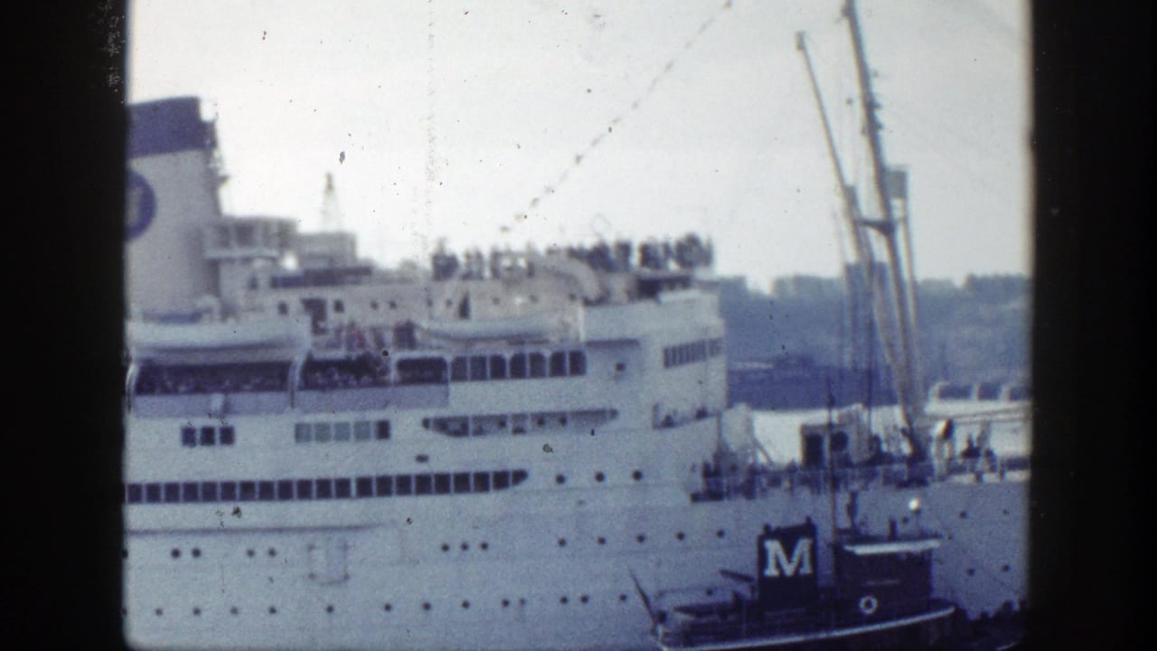 1948 New York harbor footage showing a large white ocean liner at port, passengers on upper decks, and a small tugboat alongside.