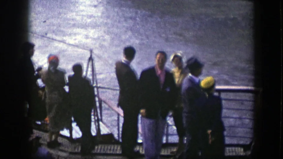 Ship deck scene in 1948 New York showing well-dressed passengers gathered by railings, with harbor water behind them.