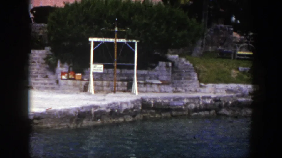 1948 8mm view of a landscaped New York waterfront, with stone steps leading up to a white frame and cross-like center.