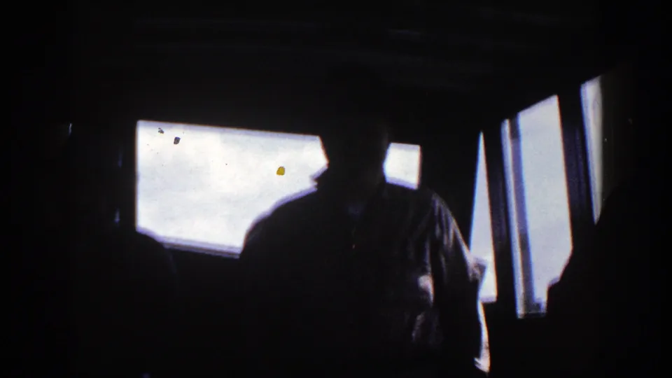 A central silhouetted adult stands in the boat cockpit, backlit by bright windows during the 1948 New York outing.