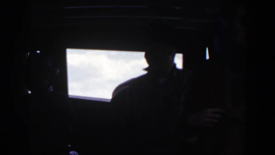 A low-light cockpit frame shows a silhouetted passenger below overexposed windows in the 1948 New York boating footage.