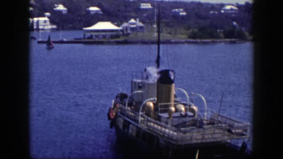 1948 New York harbor frame showing the steam boat from above or shore, with blue water and distant waterfront structures.
