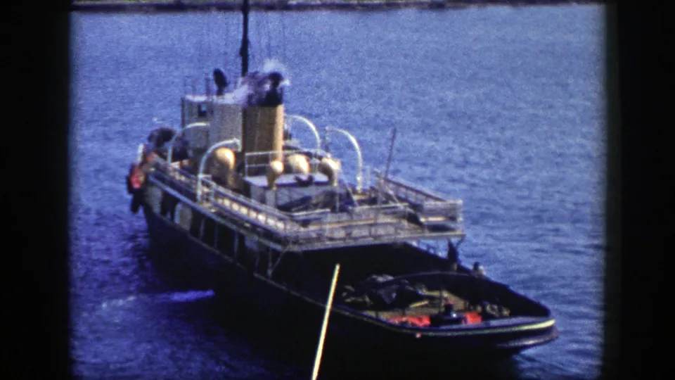1948 New York frame of a rail-decked steam vessel on water, with smoke at the stack and a small boat alongside.