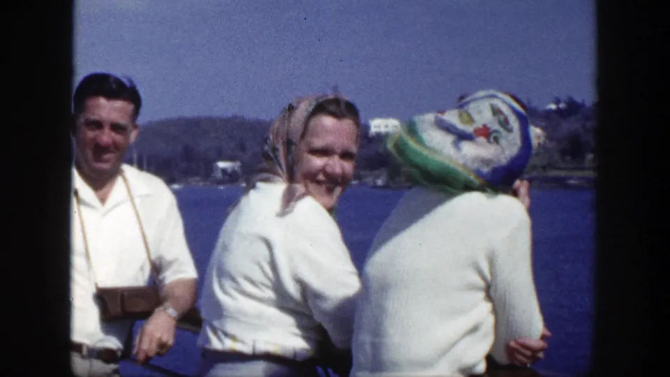 Family members stand by the New York waterfront in 1948, including a man with a camera and two women in headscarves.
