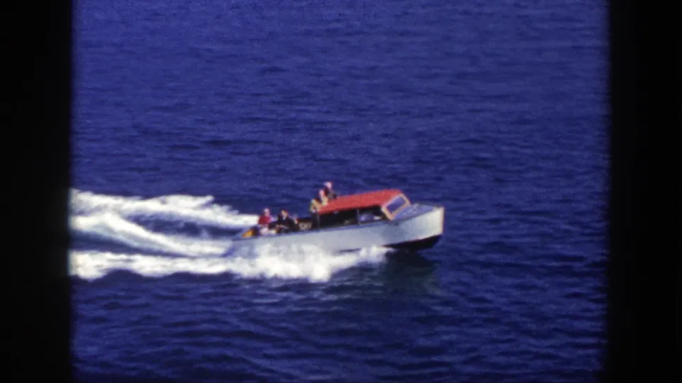 Final frame shows the red and white motorboat on blue open water, with passengers visible and wake spreading behind.