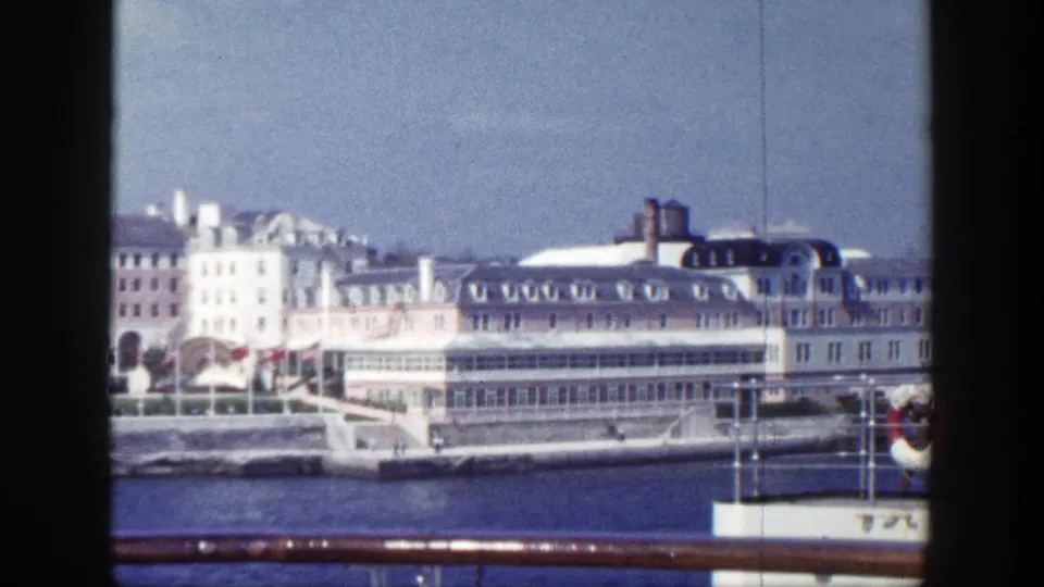 1948 New York waterfront view from a moving vessel, showing a large light-colored building along the shore.
