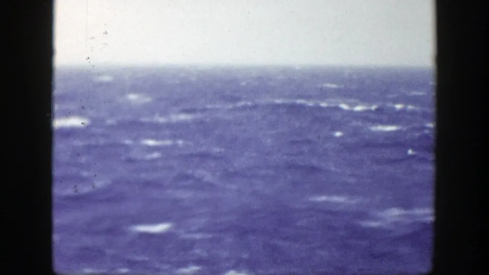 Blue ocean and scattered whitecaps appear beneath a pale sky in this 1948 8mm New York home-movie frame.