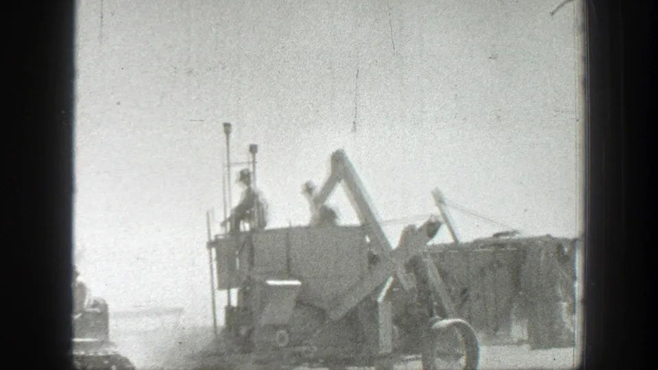 1939 California home-movie frame showing uniformed soldiers on a large military vehicle in a bright, dusty roadside landscape.