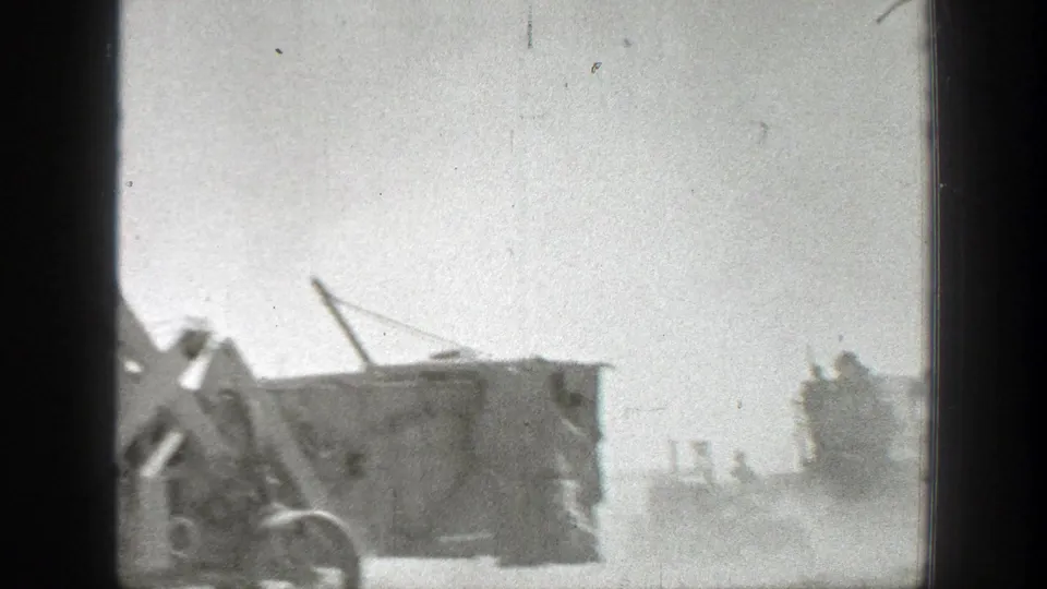 Dusty 1939 California road scene with a military vehicle in the foreground and another vehicle moving farther back.