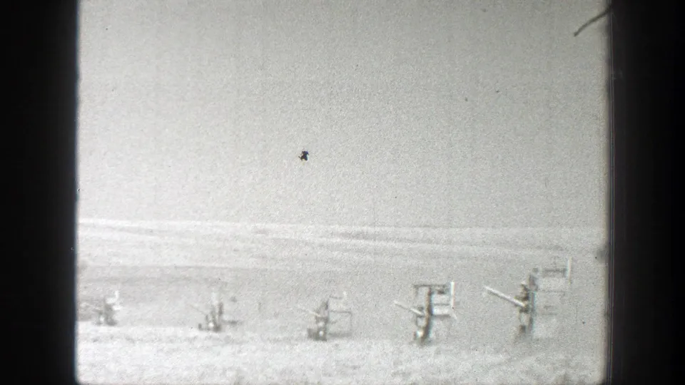 A wide California field view shows scattered small structures or equipment in grainy 1939 8mm footage.