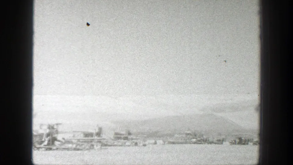 1939 California landscape frame with a long, static view of open terrain and small equipment or vehicles in the distance.