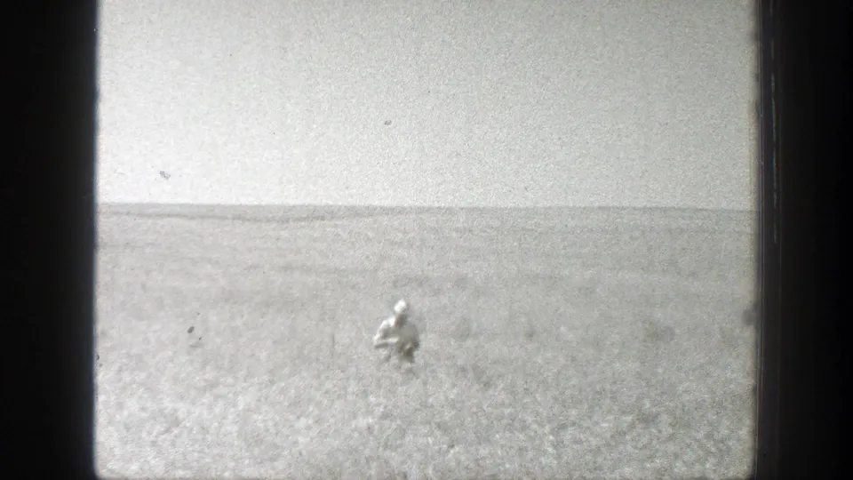 A lone adult figure is visible in a wide California field, emphasizing the scale of the rural landscape in the 1939 home movie.