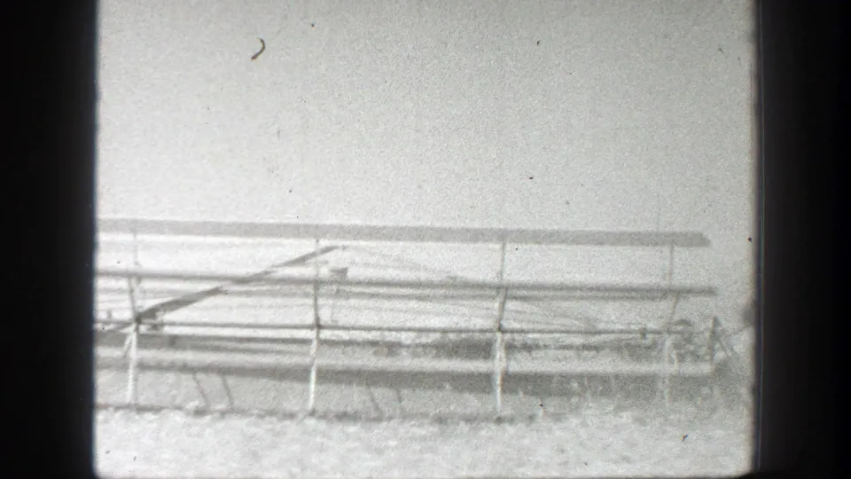 A large farm implement or rail-like frame appears in a California field within the 1939 home-movie footage.
