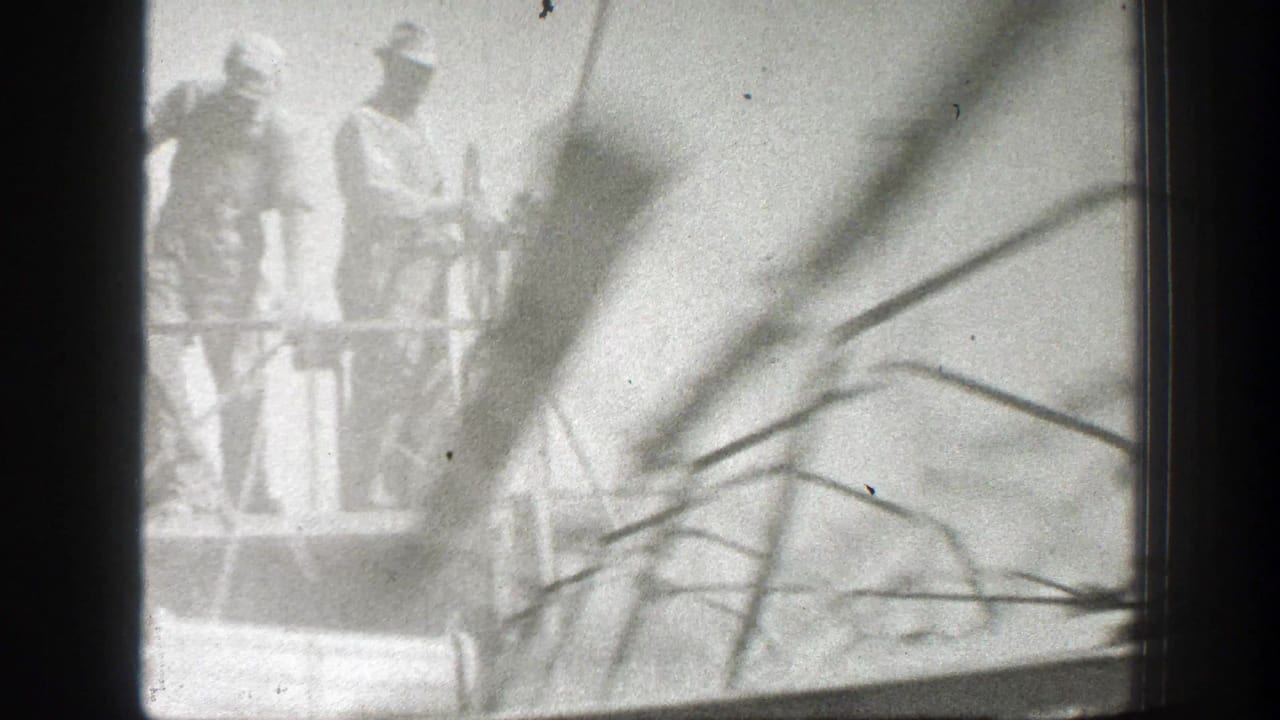 1939 California farm footage showing workers near large agricultural equipment, with soft focus and visible 8mm film borders.