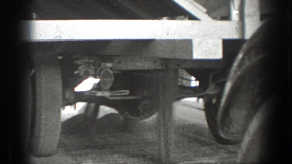 Close 8mm view of the underside of a stopped truck, with rear axle, wheels, and chassis visible.