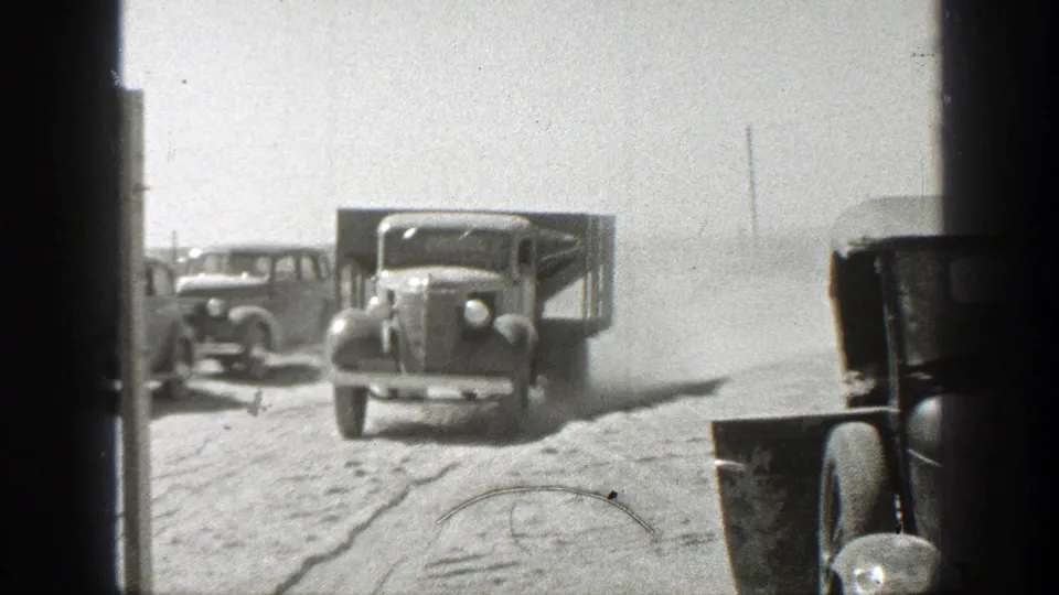 Dusty California roadside view with vintage cars and a truck facing the camera, consistent with the supplied 1939 date.