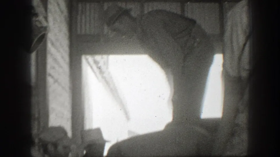The final frame is underexposed, showing a partial worker silhouette, sacks, vertical supports, and bright light from an opening.