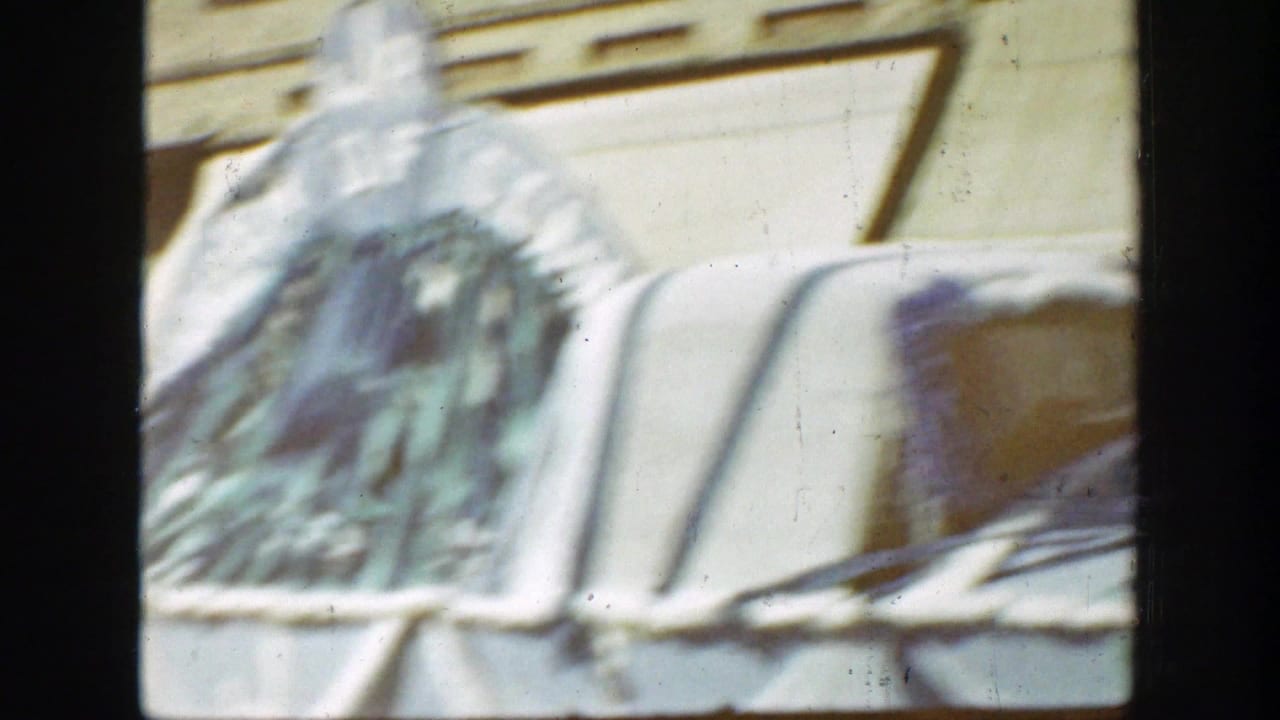1939 California 8mm frame showing a close, soft-focus view of a patriotic parade float with pale bunting and a sculptural element.