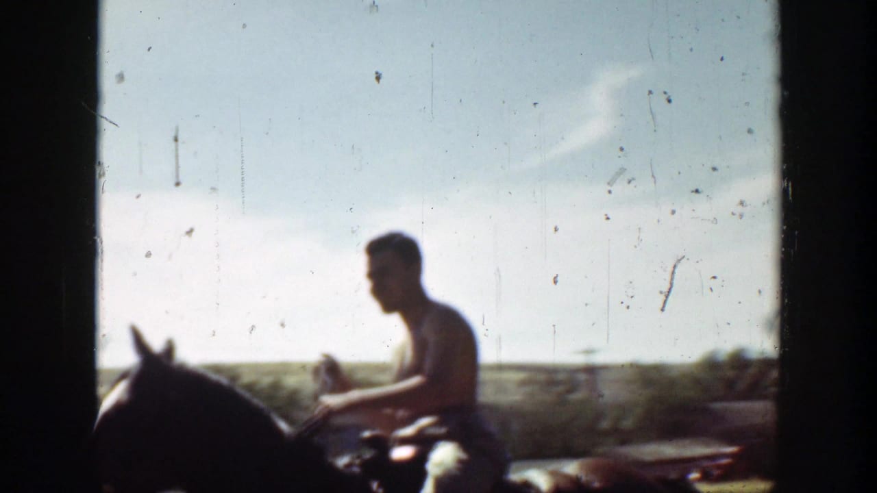 Shirtless man in profile riding a dark horse across a bright open field.