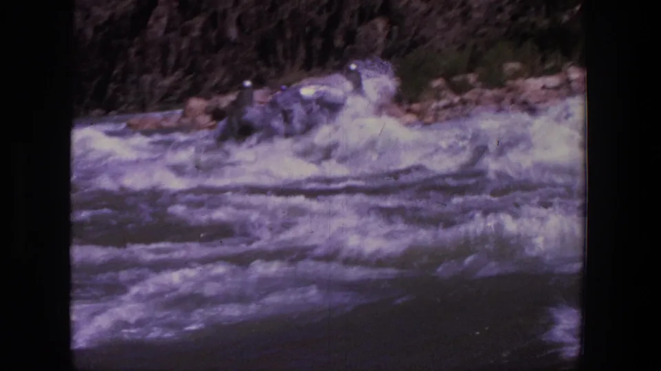 1969 Utah 8mm frame with the rafting party partly hidden by spray as rapids fill the foreground.