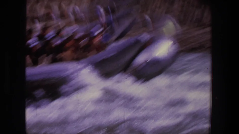 Utah 1969 home-movie frame of an inflatable raft rushing through whitewater, blurred by motion and handheld filming.