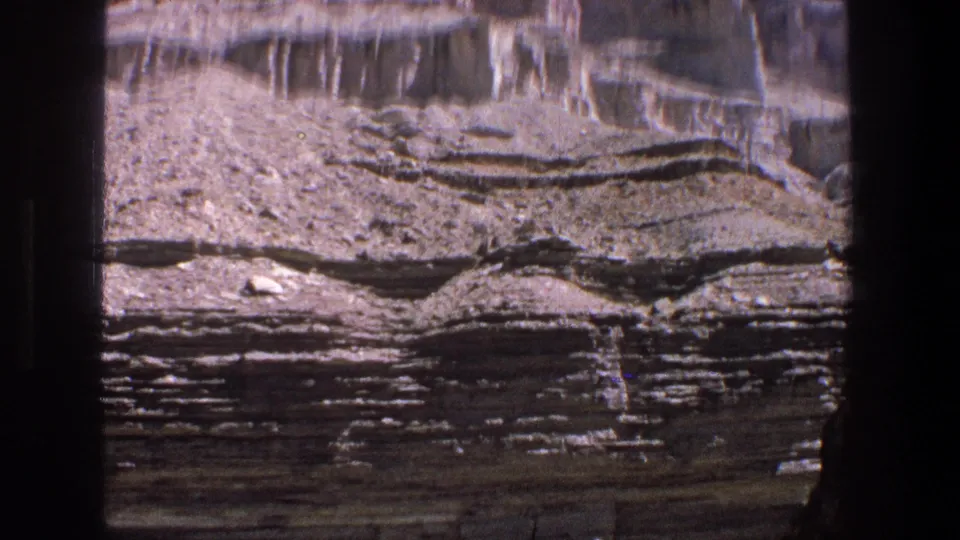 Utah desert canyon rock layers fill the frame in 1969 8mm home-movie footage.