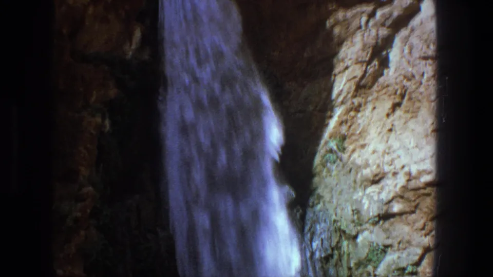 1969 Utah 8mm frame showing the waterfall lower in the rock formation during the downward pan.