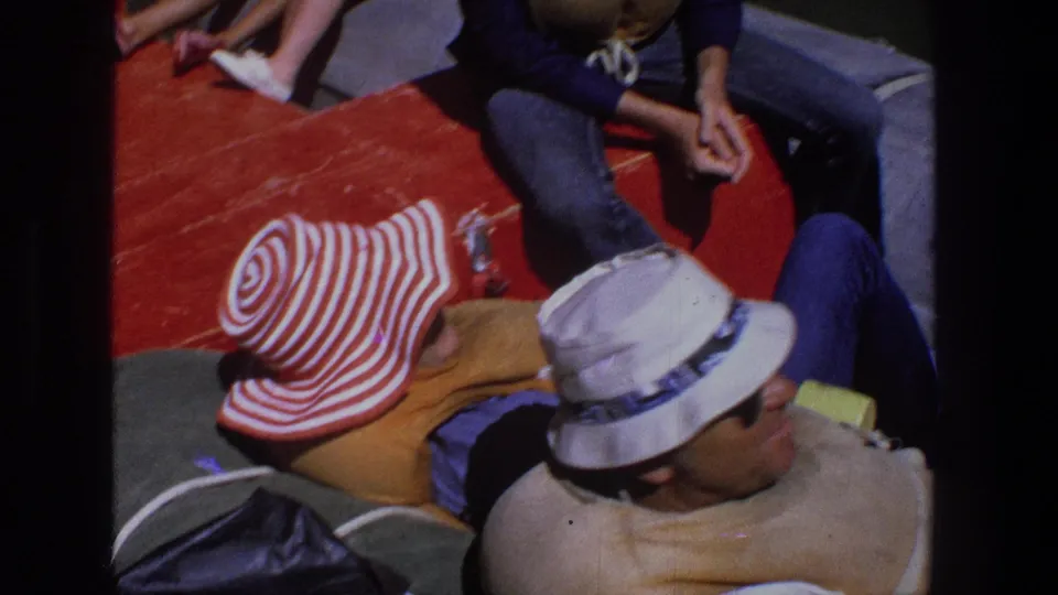 1969 Utah overhead home-movie view of adults on a boat, including a red-and-white striped hat and a man in a white hat.