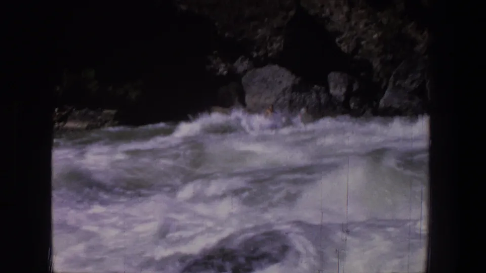 1969 Utah 8mm frame showing turbulent whitewater and rocks, with no raft clearly visible in this sampled moment.