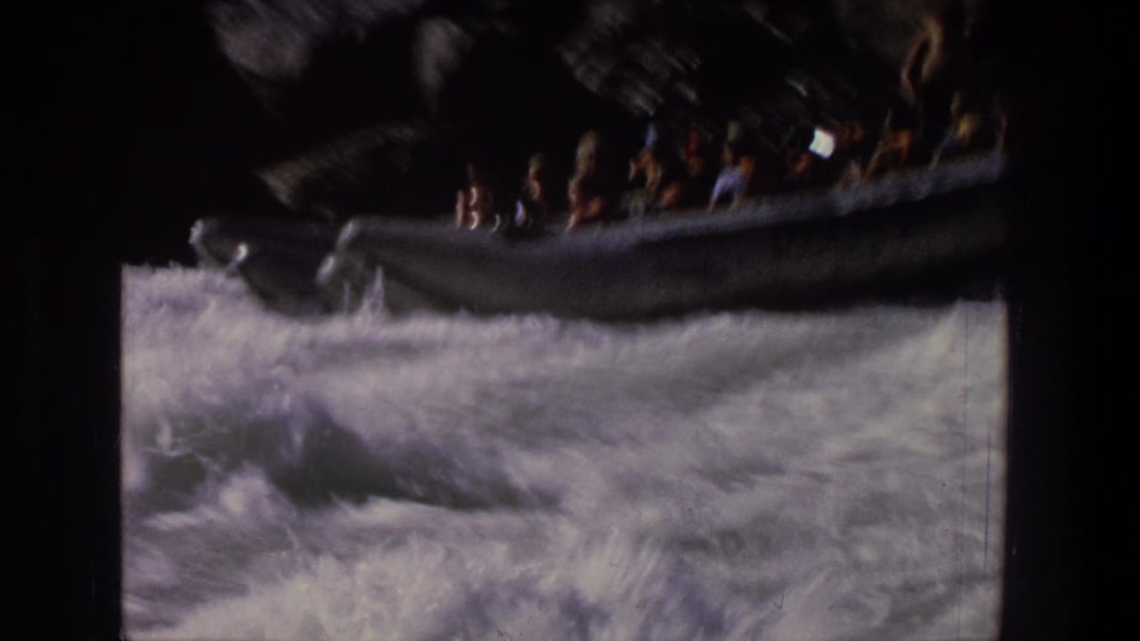 1969 Utah rafting footage shows a silver inflatable raft carrying passengers through churning white water.