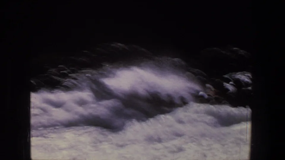 Whitewater fills the 8mm frame, emphasizing turbulent current and spray during the rafting run.