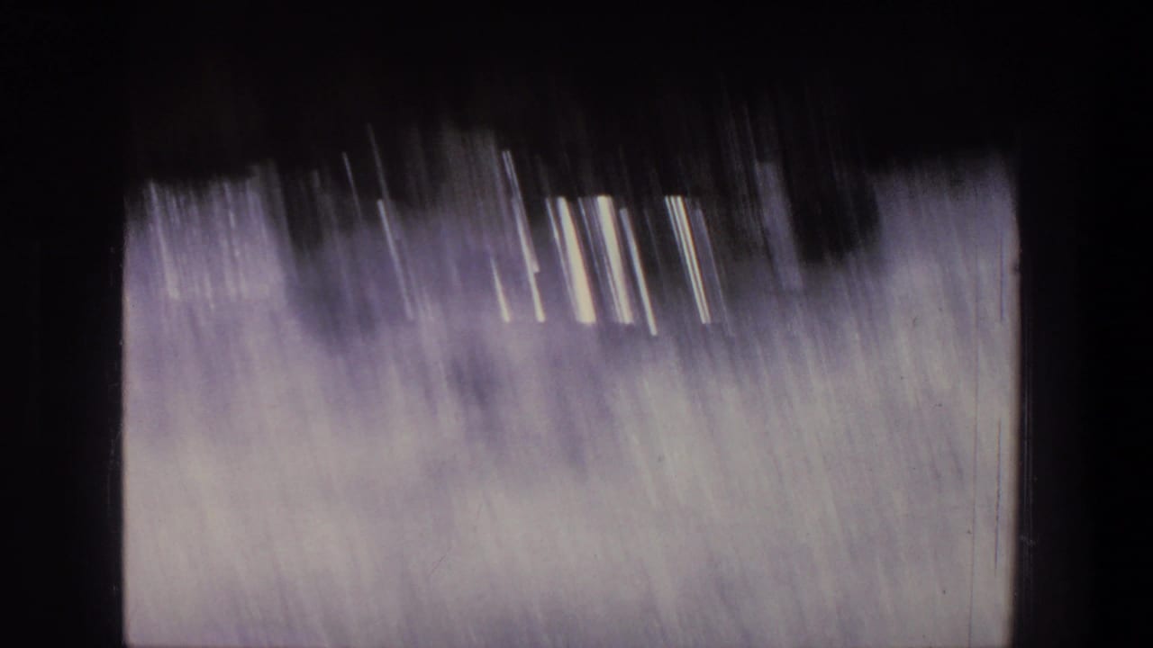1969 Utah 8mm frame showing motion-blurred whitewater, dark framing edges, and the soft exposure of home-movie film.