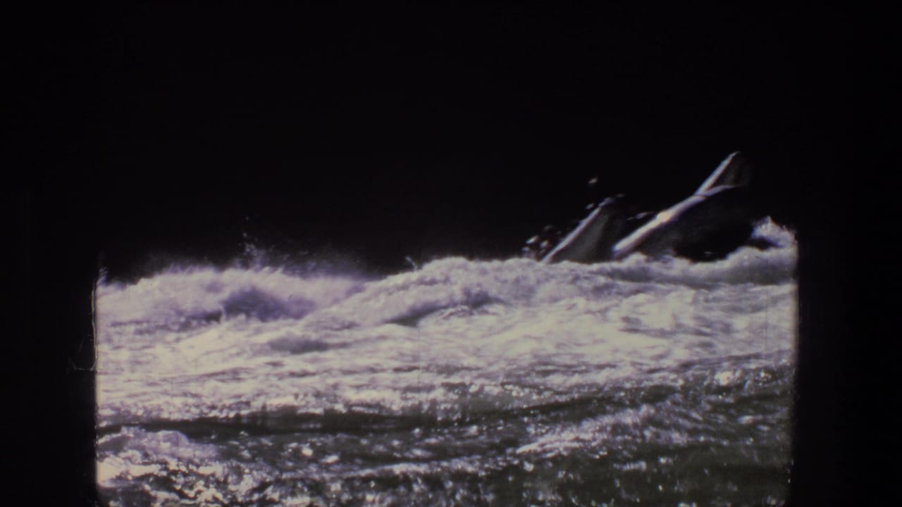 Inflatable raft entering rough whitewater with dark silhouettes partly visible.
