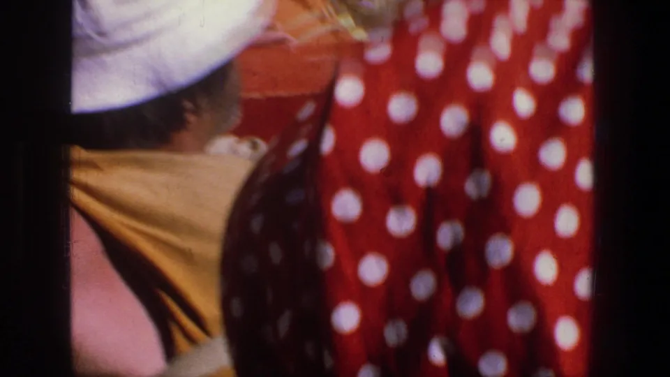 1969 Utah 8mm close-up of people in the open boat, including a white hat and red polka-dot garment, during the river trip.