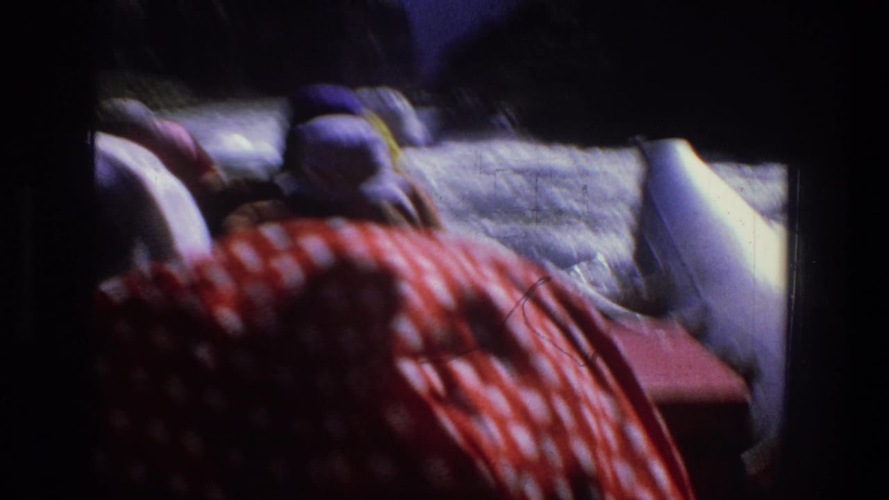 Rafters in hats ride through whitewater with red polka-dot fabric in the foreground.