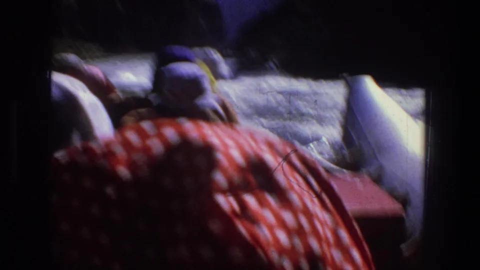 1969 Utah 8mm frame showing rafters in hats moving through whitewater, filmed from inside or behind the raft.