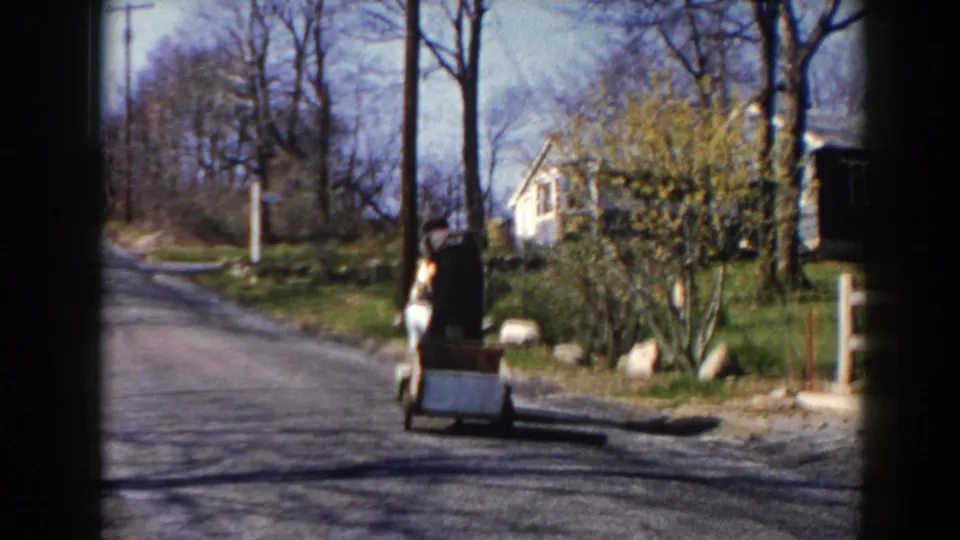 The women continue down a Pequot Lakes rural road on the motorized cart, with a small trailer following behind.