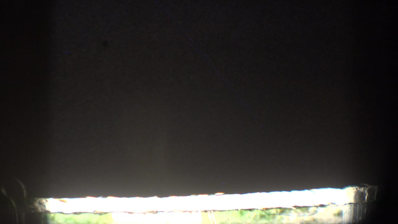 Dark film frame with a narrow bright strip near the lower edge.